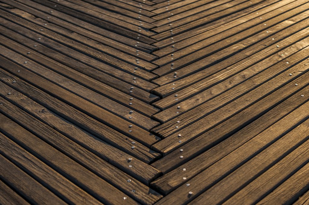 Natual wooden floors forming a V shape.